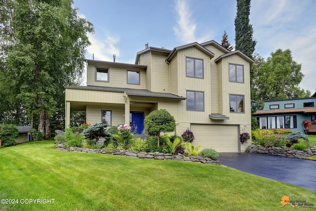 view of front of property featuring a garage and a front lawn