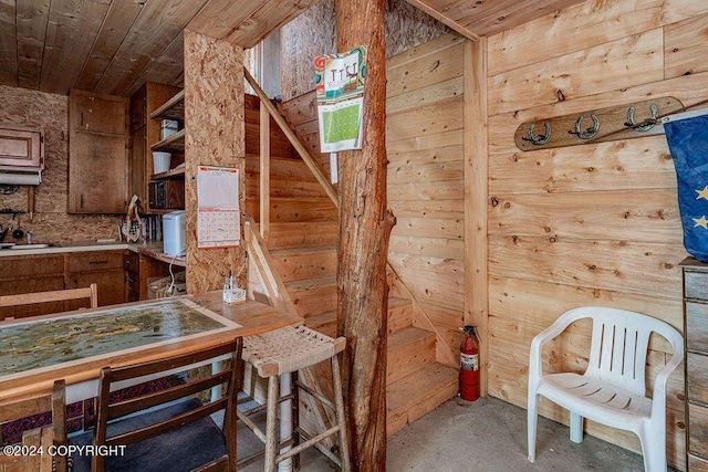 kitchen with wood walls and wooden ceiling