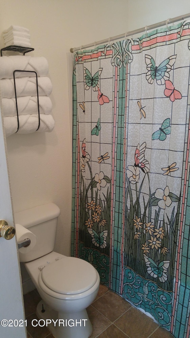 bathroom with tile patterned floors and toilet