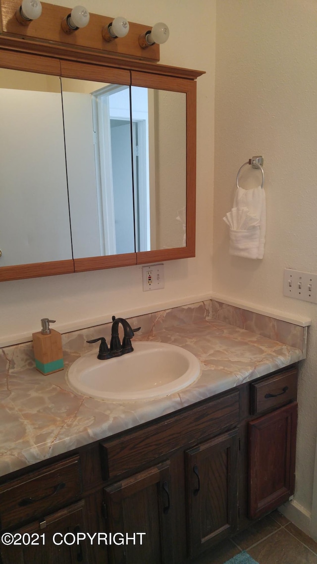 bathroom with tile patterned flooring and vanity