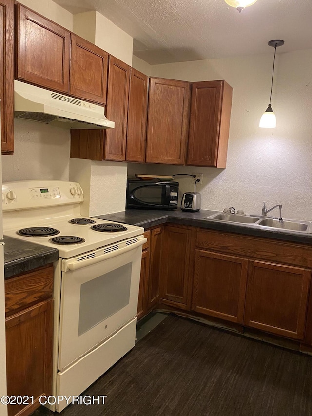 kitchen featuring white range with electric cooktop, under cabinet range hood, a sink, dark countertops, and black microwave