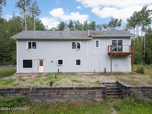 rear view of property featuring a deck