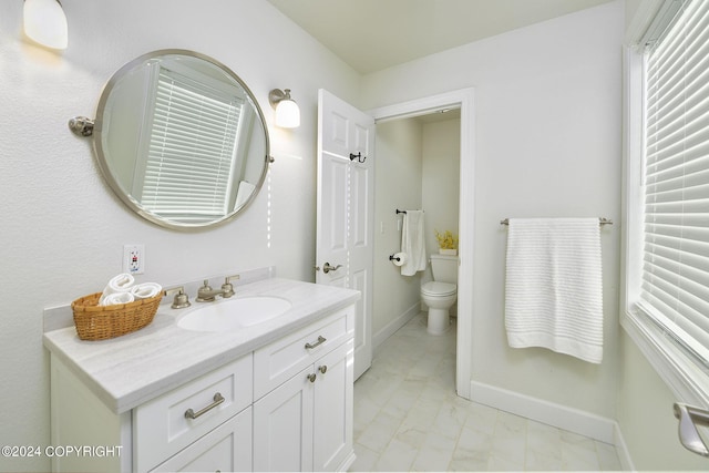 bathroom featuring vanity and toilet