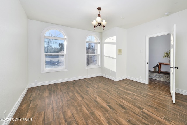 unfurnished dining area featuring dark hardwood / wood-style flooring and an inviting chandelier