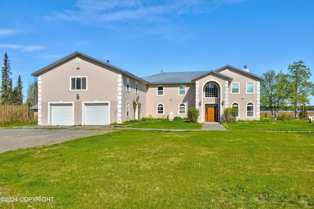 view of front of home featuring a garage and a front yard