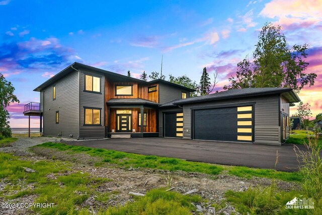 back house at dusk with a garage