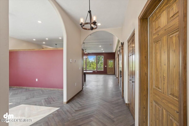 interior space with a notable chandelier and parquet flooring