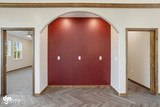 interior space with ceiling fan and parquet floors