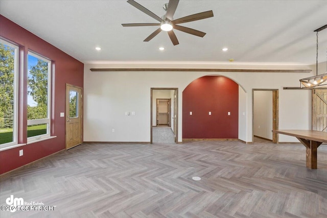 empty room with light parquet floors and ceiling fan