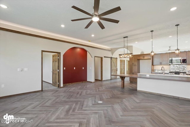 kitchen featuring dark parquet floors, sink, ceiling fan, decorative backsplash, and stove