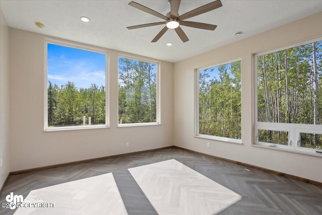 interior space featuring ceiling fan and parquet flooring