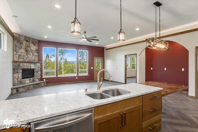 kitchen with a fireplace, dark parquet floors, sink, and a wealth of natural light