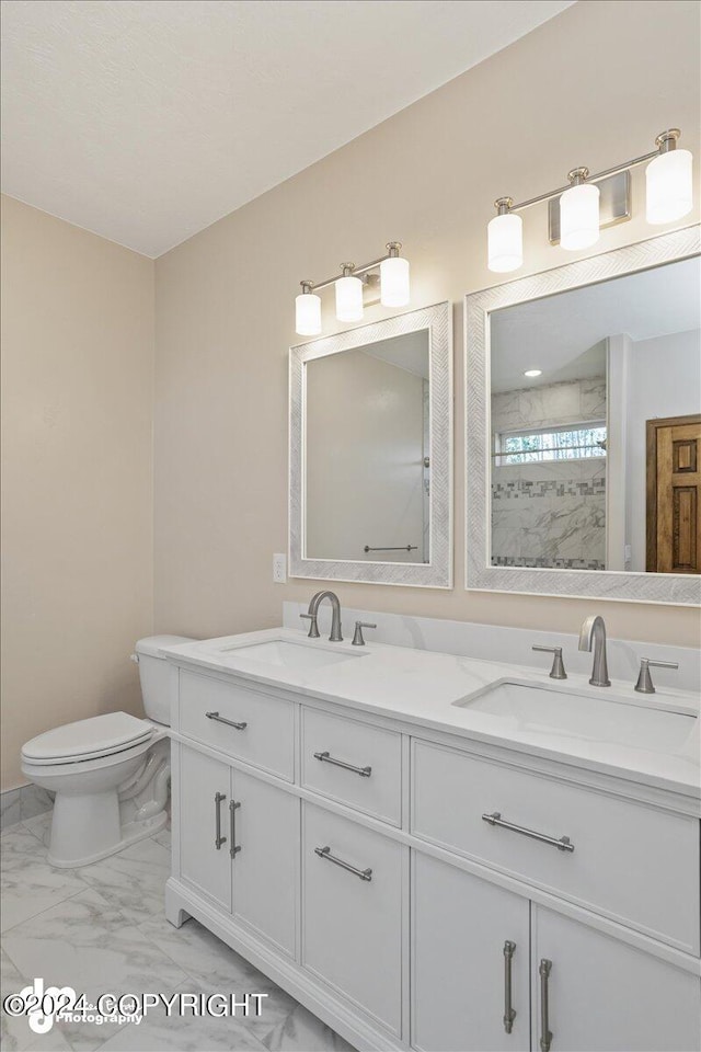 bathroom with double vanity, toilet, and tile patterned floors