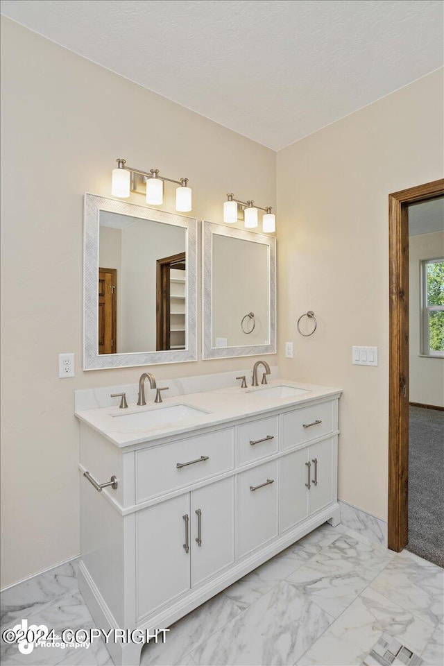 bathroom featuring dual bowl vanity and tile patterned floors