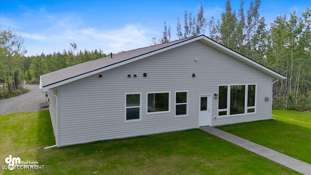 rear view of property with a yard