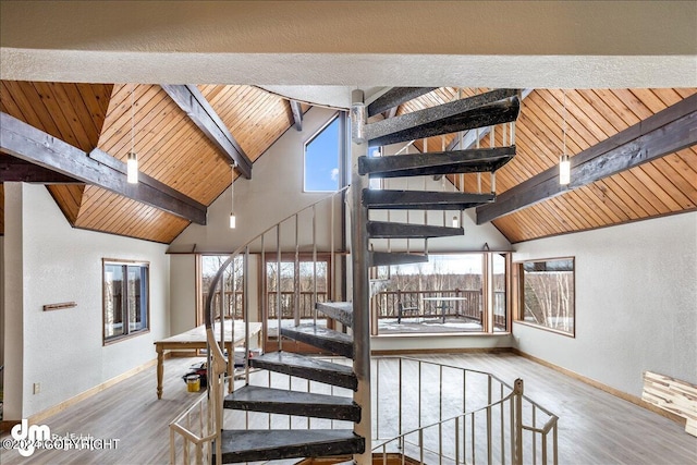 staircase featuring wood ceiling, a healthy amount of sunlight, and wood finished floors