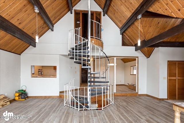 unfurnished living room featuring wood ceiling, beam ceiling, baseboards, and wood finished floors