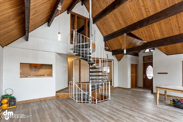 interior space with light wood-type flooring, wood ceiling, beamed ceiling, and baseboards