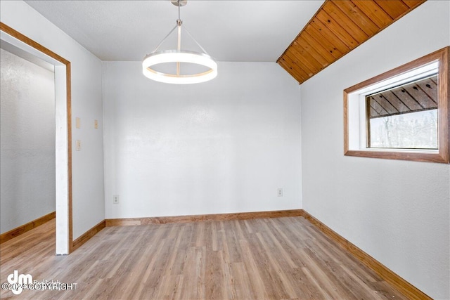 interior space with lofted ceiling, light wood-type flooring, and baseboards