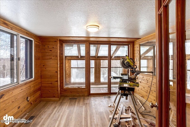 unfurnished sunroom with plenty of natural light and visible vents