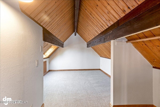 additional living space featuring lofted ceiling with beams, carpet, wood ceiling, and baseboards