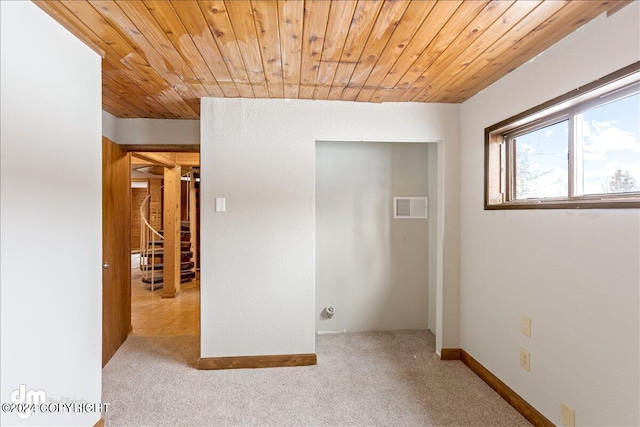 interior space featuring light carpet and wooden ceiling