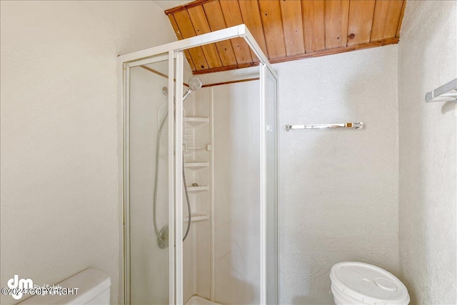 full bathroom with wooden ceiling, a shower stall, and toilet