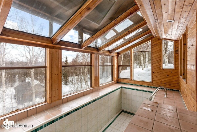 unfurnished sunroom with a hot tub, vaulted ceiling, and wooden ceiling