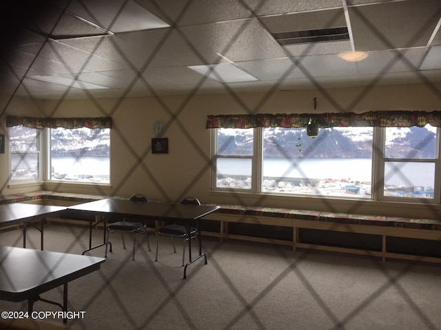 unfurnished dining area with a drop ceiling