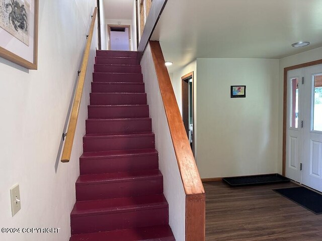 stairway with hardwood / wood-style flooring