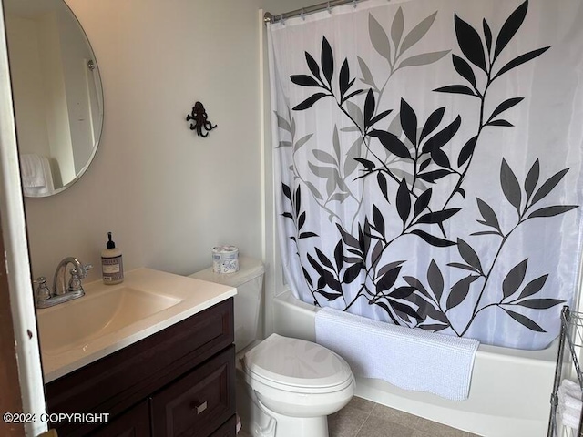 full bathroom with shower / bath combo with shower curtain, tile patterned floors, vanity, and toilet