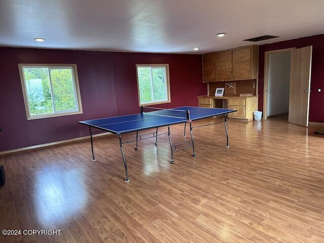 recreation room with light wood-type flooring and a healthy amount of sunlight