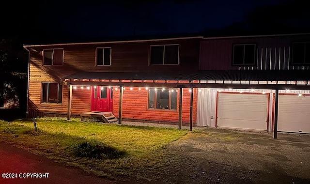 view of front facade featuring a lawn and a garage