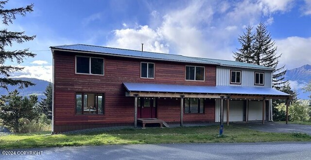 view of front of property with a garage and a front yard