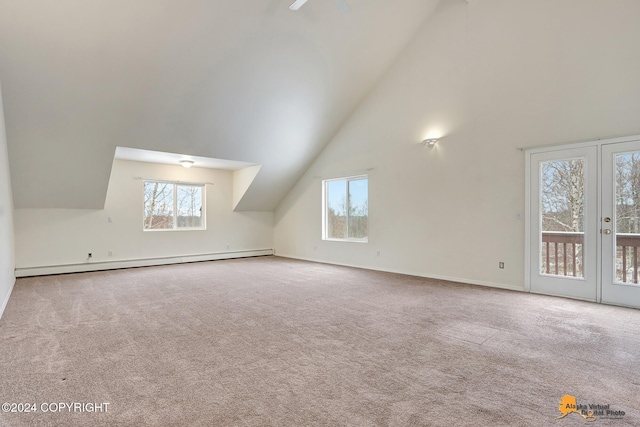 additional living space featuring baseboard heating, carpet flooring, and plenty of natural light