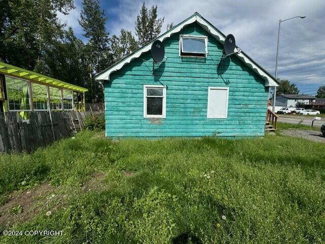 view of side of home featuring a yard