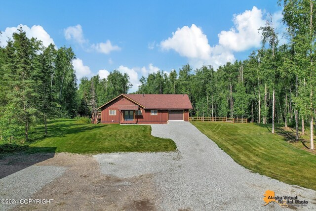 view of front of home featuring a garage and a front lawn