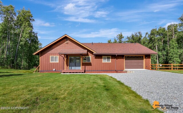 single story home with a garage and a front lawn