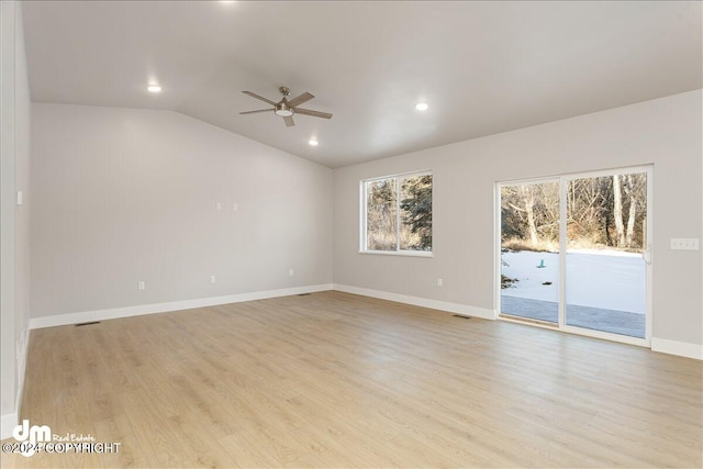 spare room featuring ceiling fan, light hardwood / wood-style flooring, and vaulted ceiling