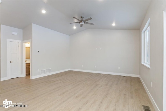 empty room featuring ceiling fan, light hardwood / wood-style flooring, and vaulted ceiling