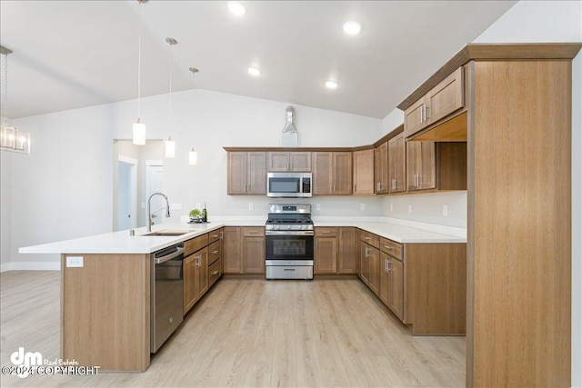 kitchen with stainless steel appliances, sink, kitchen peninsula, decorative light fixtures, and lofted ceiling