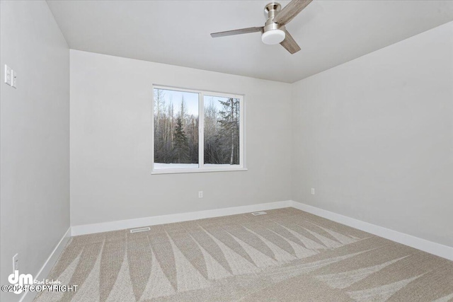 spare room featuring carpet floors and ceiling fan