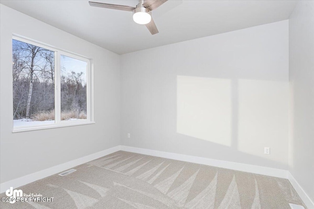 empty room featuring carpet flooring and ceiling fan