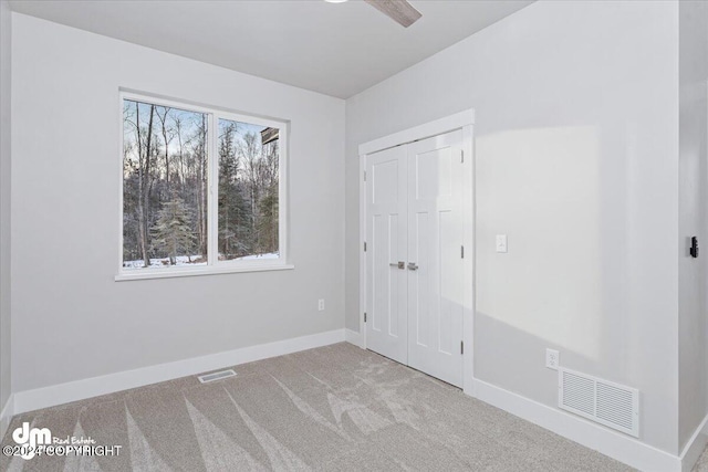 unfurnished room featuring light colored carpet