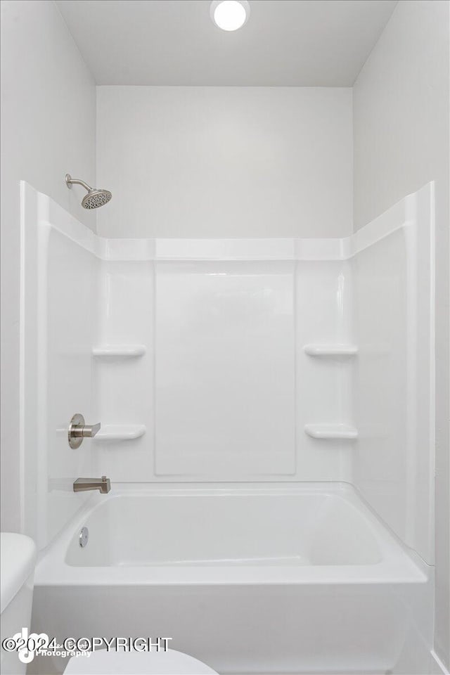 bathroom featuring toilet and tub / shower combination