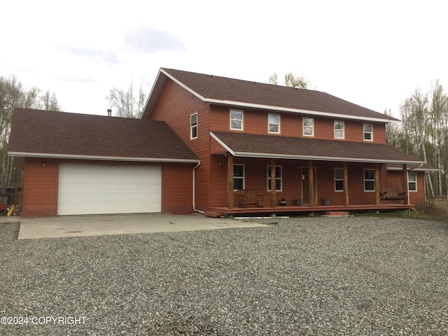 view of front of home featuring a garage and a porch