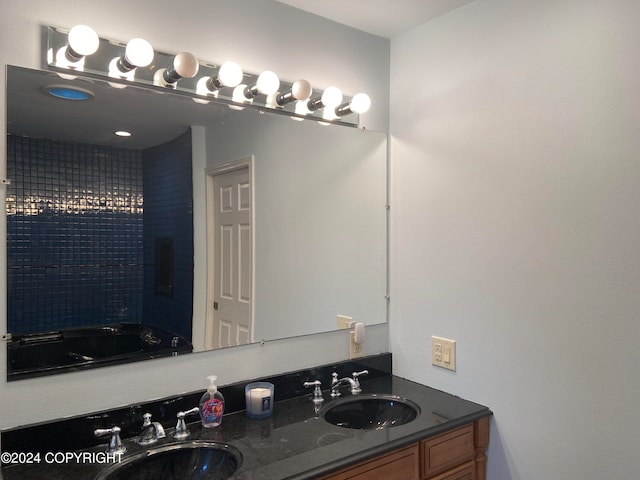 bathroom featuring a washtub and vanity