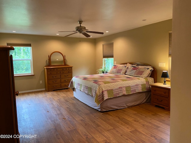 bedroom with ceiling fan and hardwood / wood-style flooring