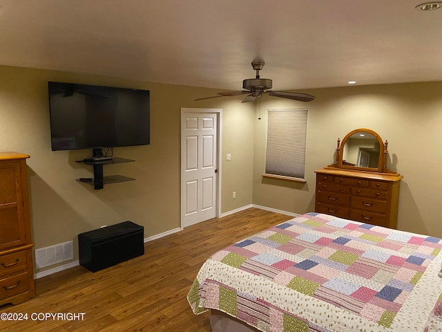 bedroom with ceiling fan and wood-type flooring