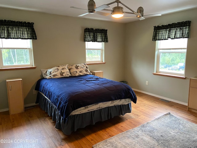 bedroom with hardwood / wood-style floors and ceiling fan